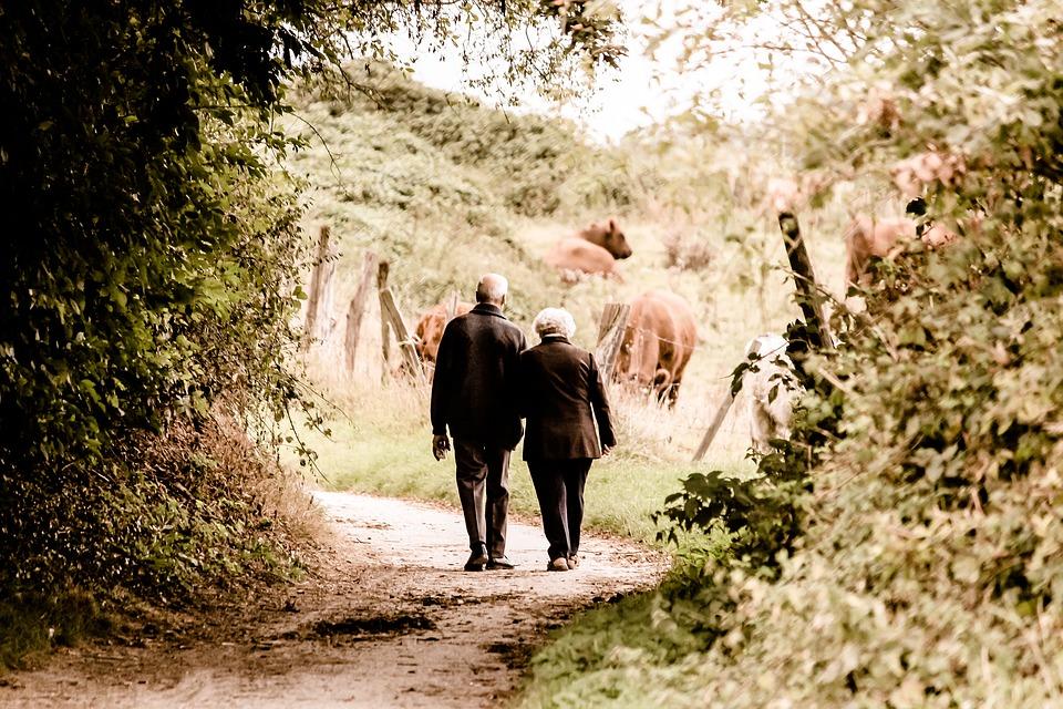 Image of an elderly couple walking together